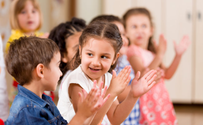 Preschool children playing in classroom.