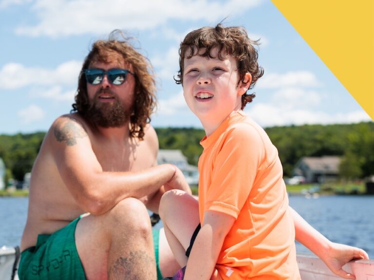 A dad and young son in a boat from the cover of The State of Vermont's Children: 2024 Year in Review