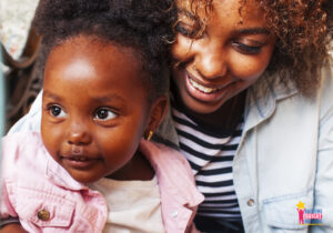 Smiling young child and parent with text "YOU ARE ENOUGH"