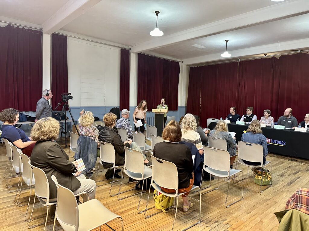 Seated audience listens to speakers at Central VT candidate forum