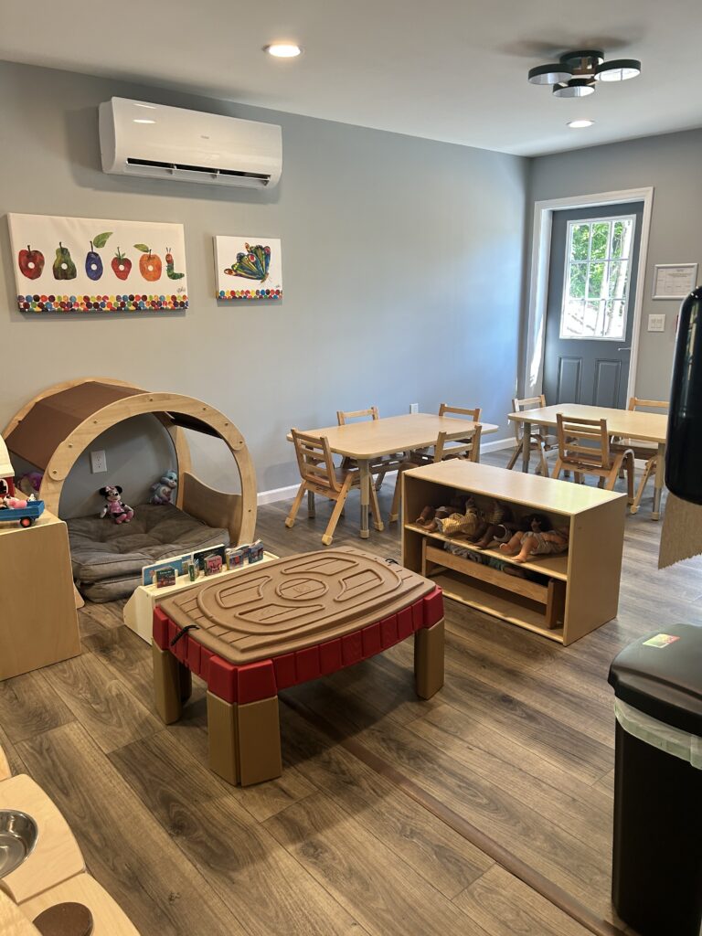 Interior of Stay & Play Child Care Center showing toys, games, tables, and chairs