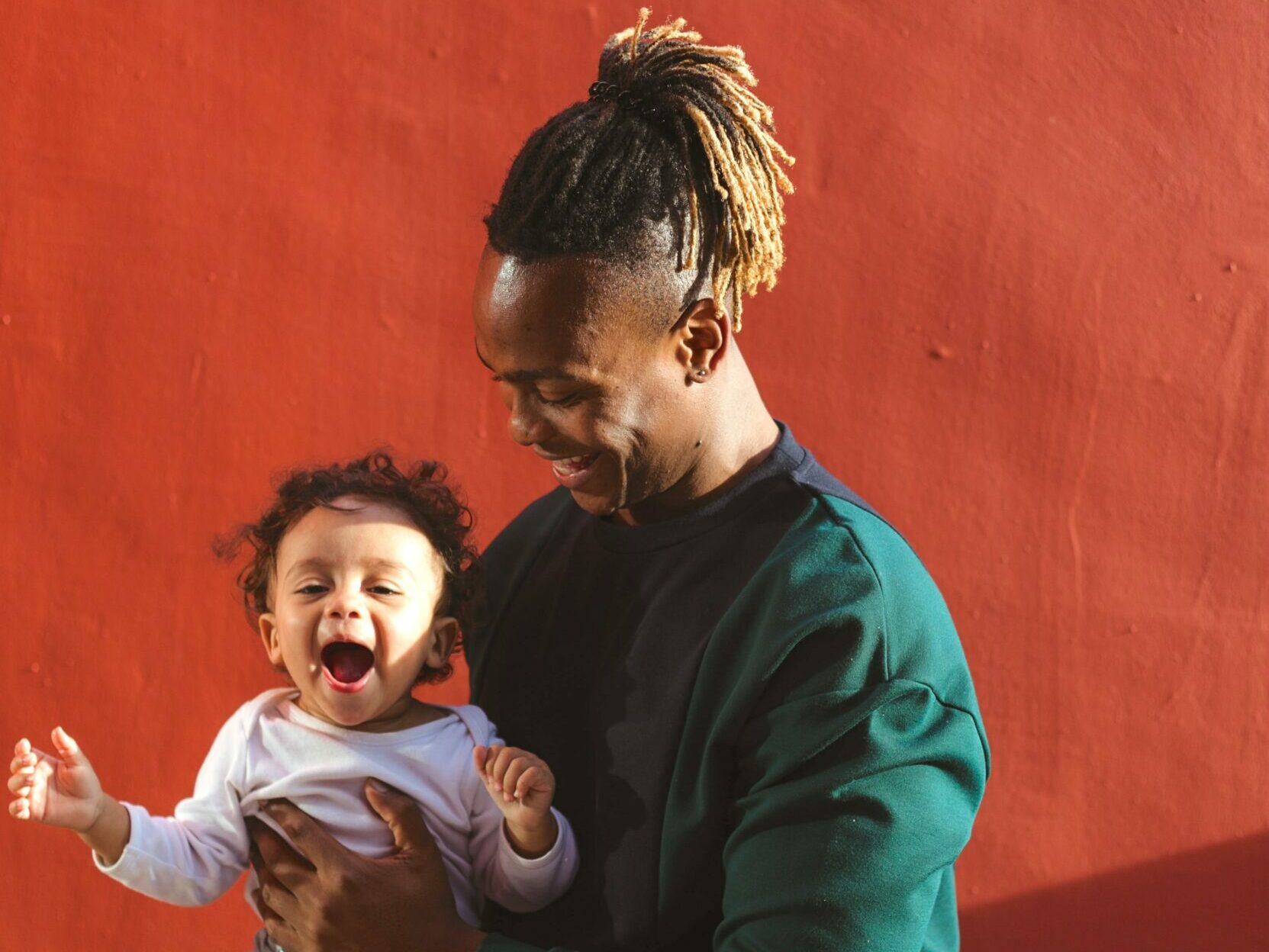 Parent holding smiling young child