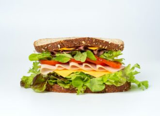 A sandwich with meat, cheese, lettuce, tomato
